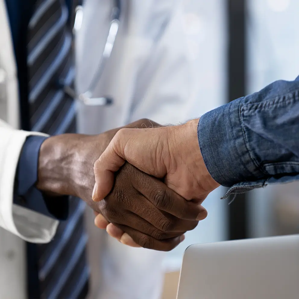 doctor shaking hands with patient at hospital