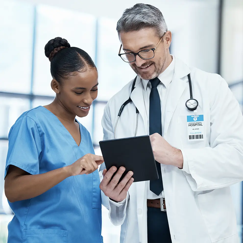 nurse and doctor reviewing patient's results on digital tablet
