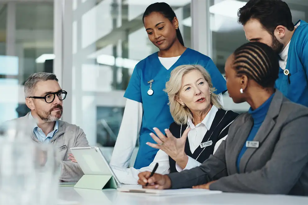 Doctors meeting with businessman at a conference table